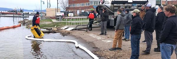 Participants on lake shore at oil spill training